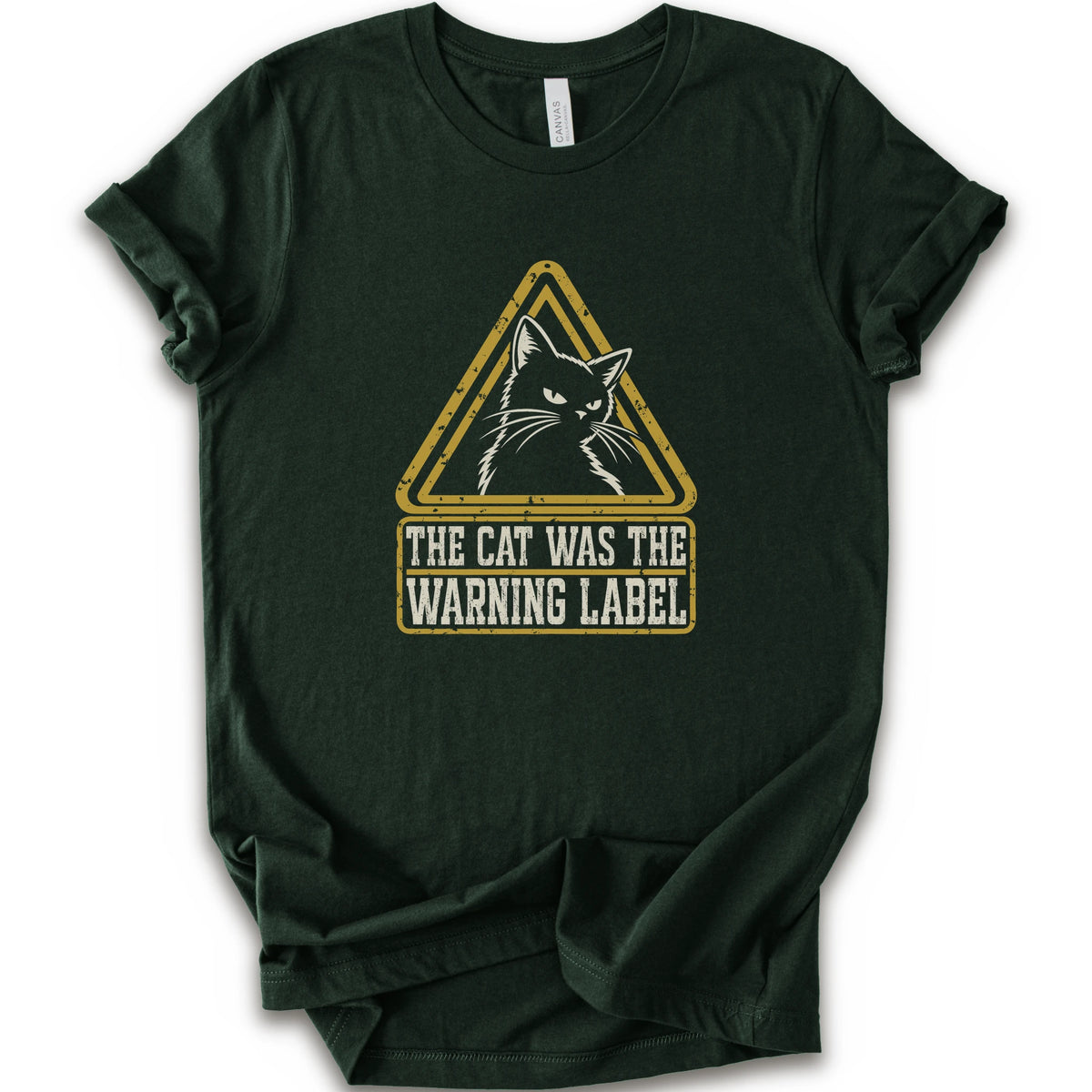 A forest short-sleeve crewneck t-shirt with a distressed yellow and white graphic on the front showing a cat inside a warning triangle and the text 'THE CAT WAS THE WARNING LABEL'.