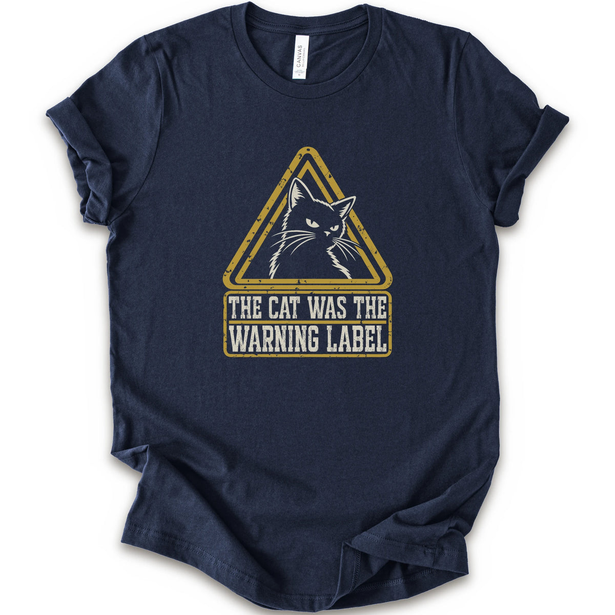 A navy short-sleeve crewneck t-shirt with a distressed yellow and white graphic on the front showing a cat inside a warning triangle and the text 'THE CAT WAS THE WARNING LABEL'.