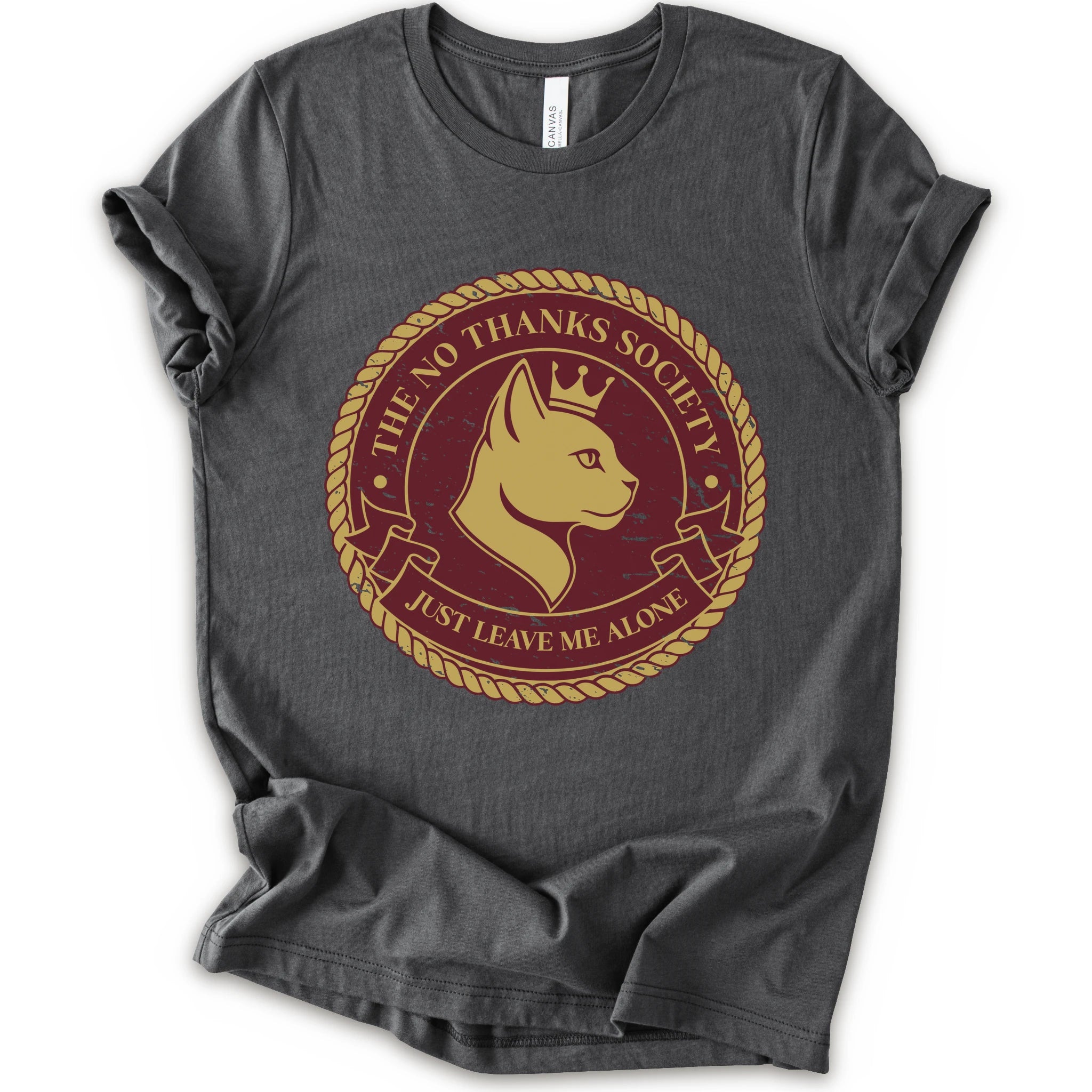 A asphalt short-sleeve t-shirt with a circular graphic print on the front. The graphic features a golden-yellow cat profile wearing a crown, surrounded by a rope border and the text 'THE NO THANKS SOCIETY' and 'JUST LEAVE ME ALONE' in a maroon background.