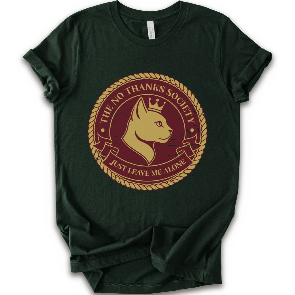 A forest short-sleeve t-shirt with a circular graphic print on the front. The graphic features a golden-yellow cat profile wearing a crown, surrounded by a rope border and the text 'THE NO THANKS SOCIETY' and 'JUST LEAVE ME ALONE' in a maroon background.
