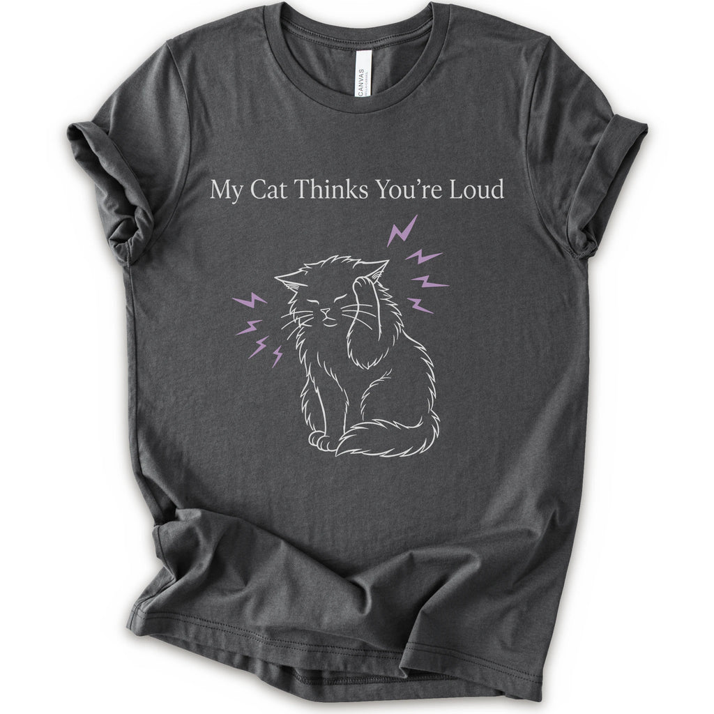 A asphalt short-sleeve t-shirt with a graphic print of a white line-art cat closing its ear, surrounded by purple lightning bolts, with the text 'My Cat Thinks You're Loud' printed above in white.