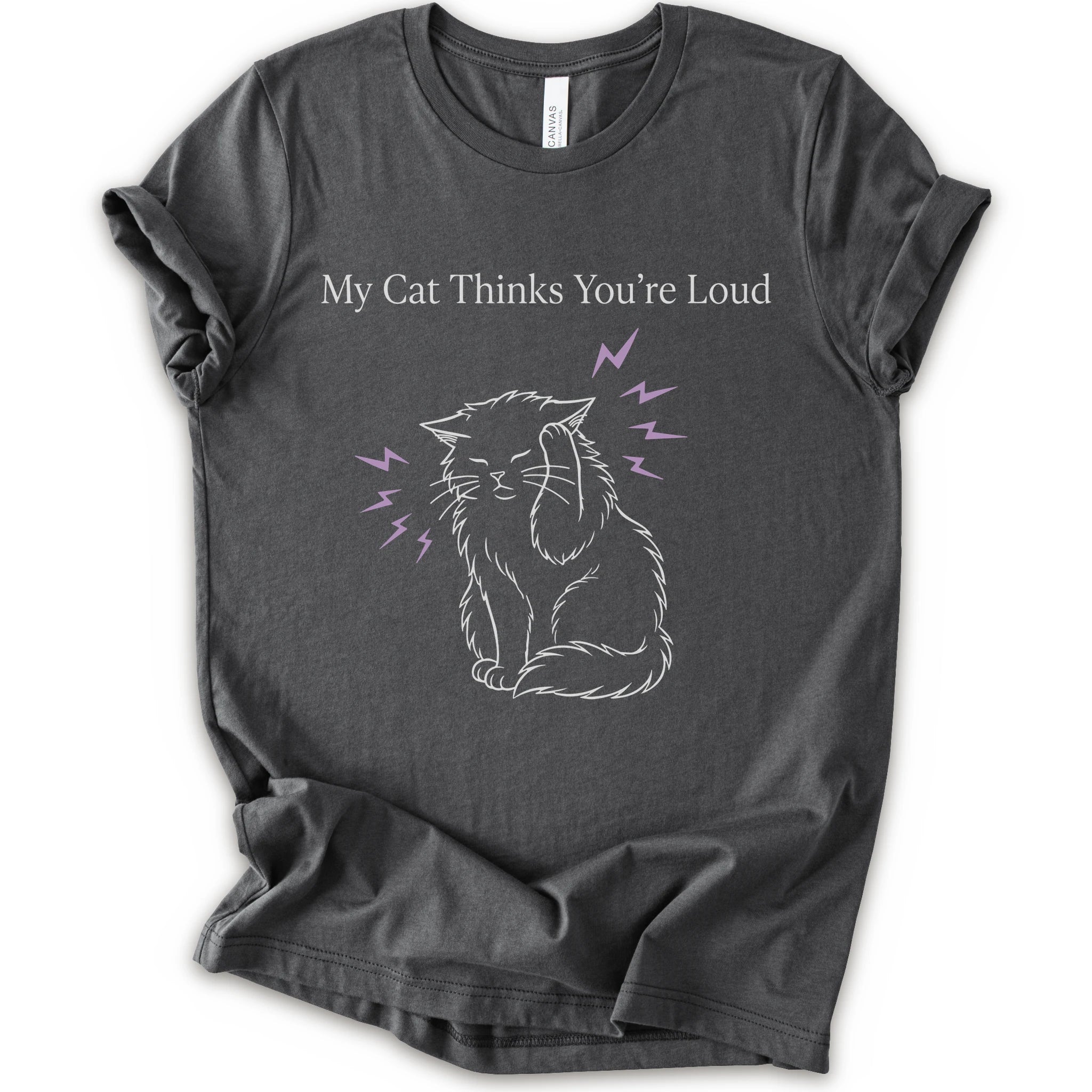 A asphalt short-sleeve t-shirt with a graphic print of a white line-art cat closing its ear, surrounded by purple lightning bolts, with the text 'My Cat Thinks You're Loud' printed above in white.