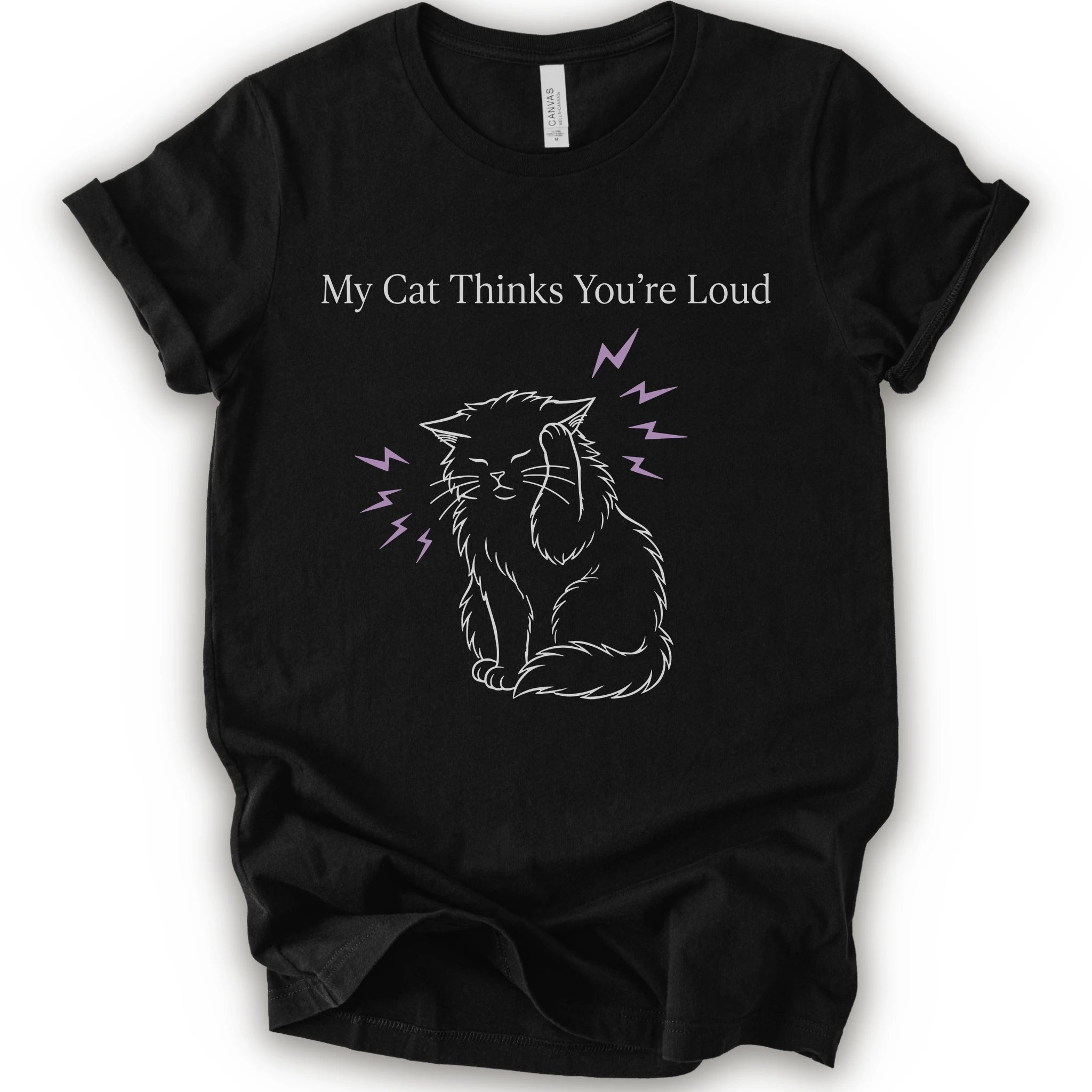 A black short-sleeve t-shirt with a graphic print of a white line-art cat closing its ear, surrounded by purple lightning bolts, with the text 'My Cat Thinks You're Loud' printed above in white.