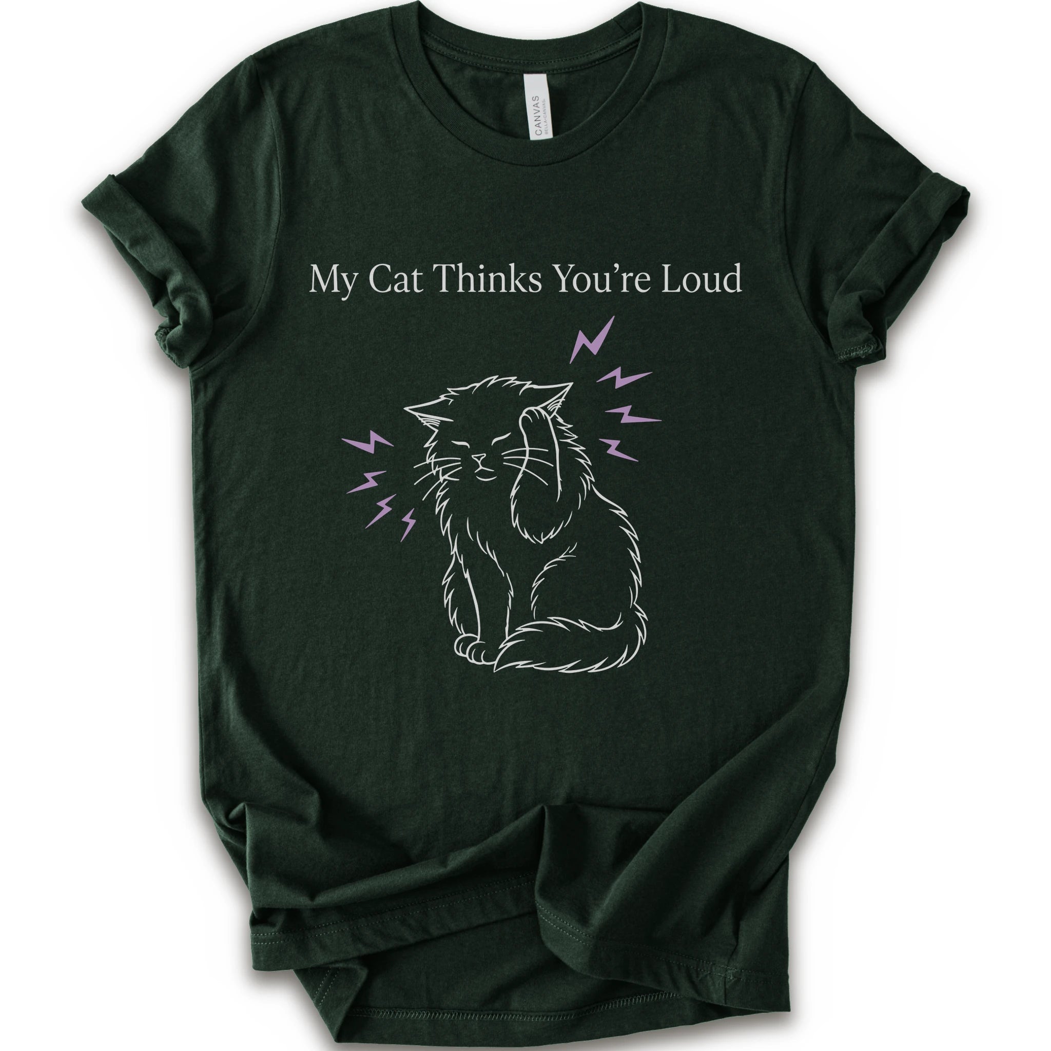 A forest short-sleeve t-shirt with a graphic print of a white line-art cat closing its ear, surrounded by purple lightning bolts, with the text 'My Cat Thinks You're Loud' printed above in white.
