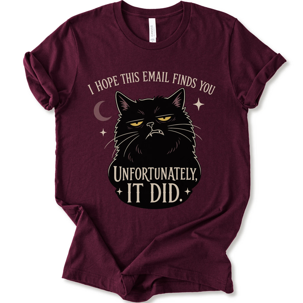 Maroon graphic t-shirt with a black cat with yellow eyes beneath “I Hope This Email Finds You” and above “Unfortunately, It Did.”