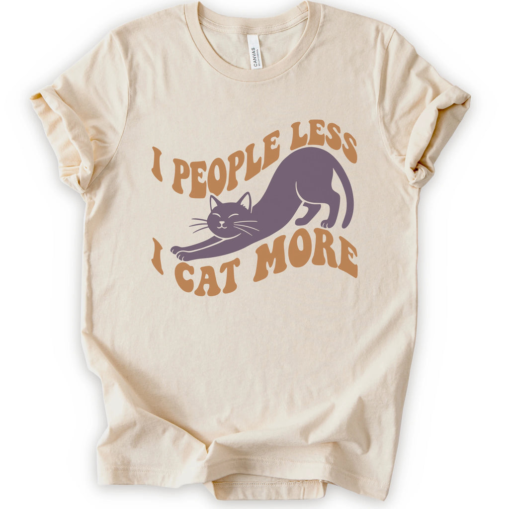 A natural short-sleeve crewneck t-shirt with a graphic of a stretching purple cat and the text 'I PEOPLE LESS I CAT MORE' in orange.