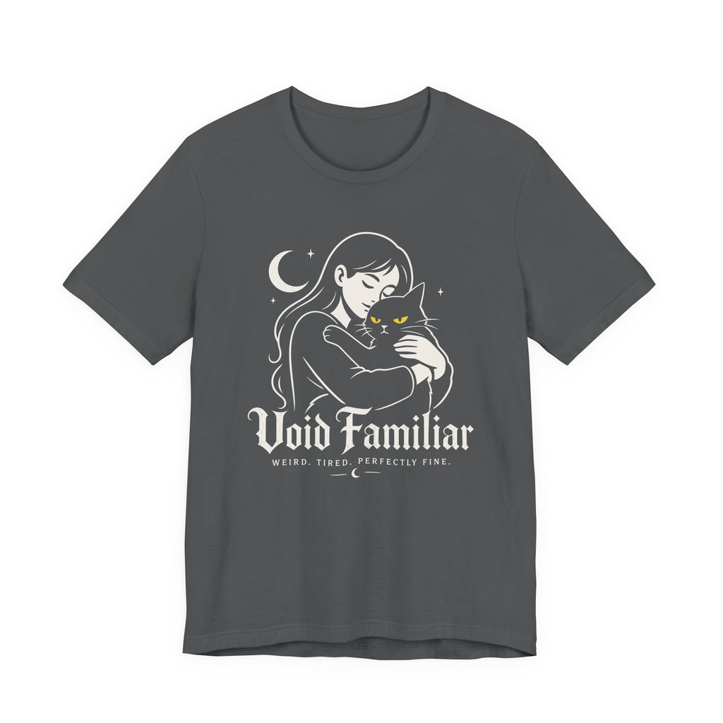 Asphalt grey Tee with Woman hugging a black cat beneath a crescent moon with “Void Familiar” and “Weird. Tired. Perfectly Fine.” text