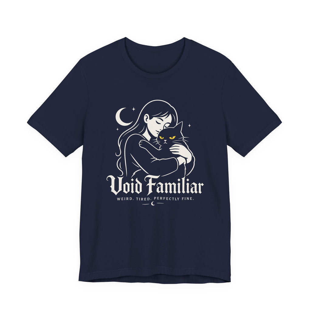 A Navy Tee with Woman hugging a black cat beneath a crescent moon with “Void Familiar” and “Weird. Tired. Perfectly Fine.” text