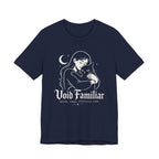 A Navy Tee with Woman hugging a black cat beneath a crescent moon with “Void Familiar” and “Weird. Tired. Perfectly Fine.” text