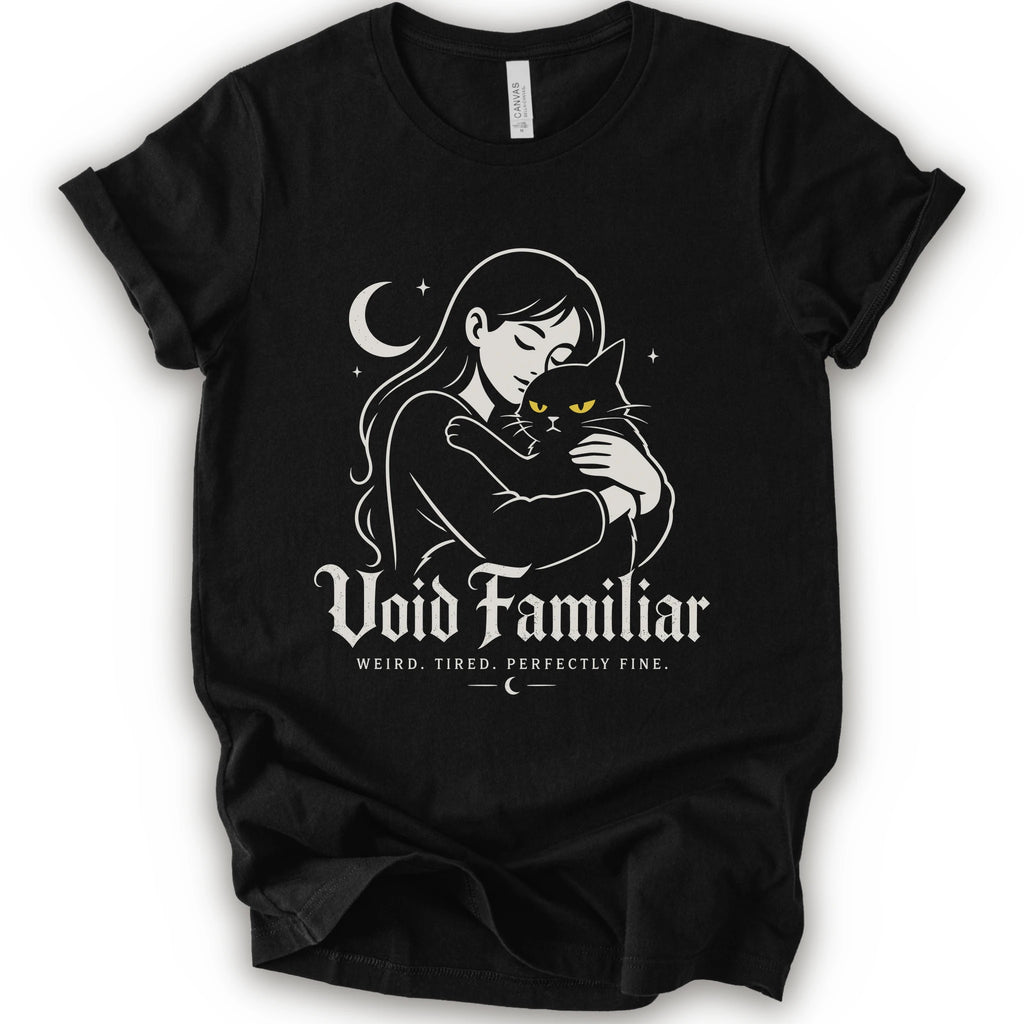 Black graphic t-shirt with a woman hugging a black cat beneath a crescent moon with “Void Familiar” and “Weird. Tired. Perfectly Fine.” text