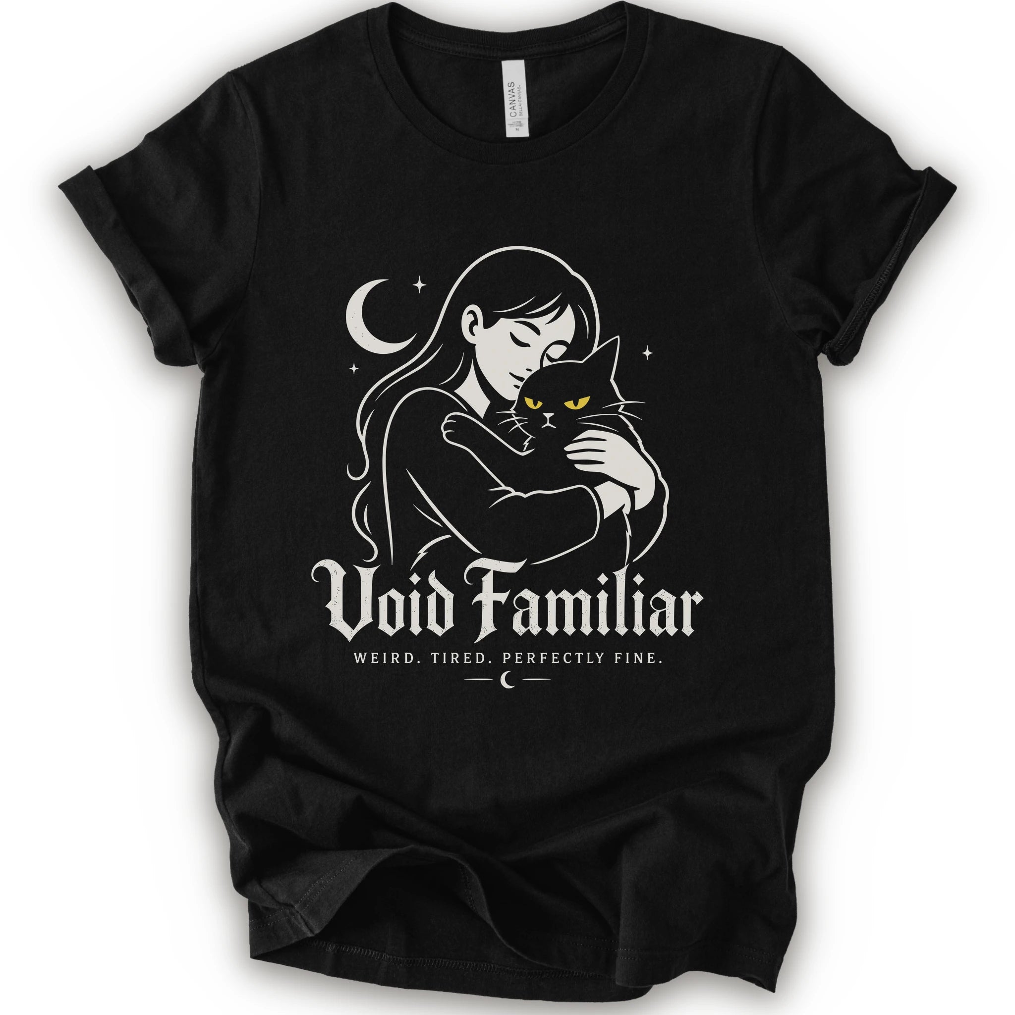 Black graphic t-shirt with a woman hugging a black cat beneath a crescent moon with “Void Familiar” and “Weird. Tired. Perfectly Fine.” text