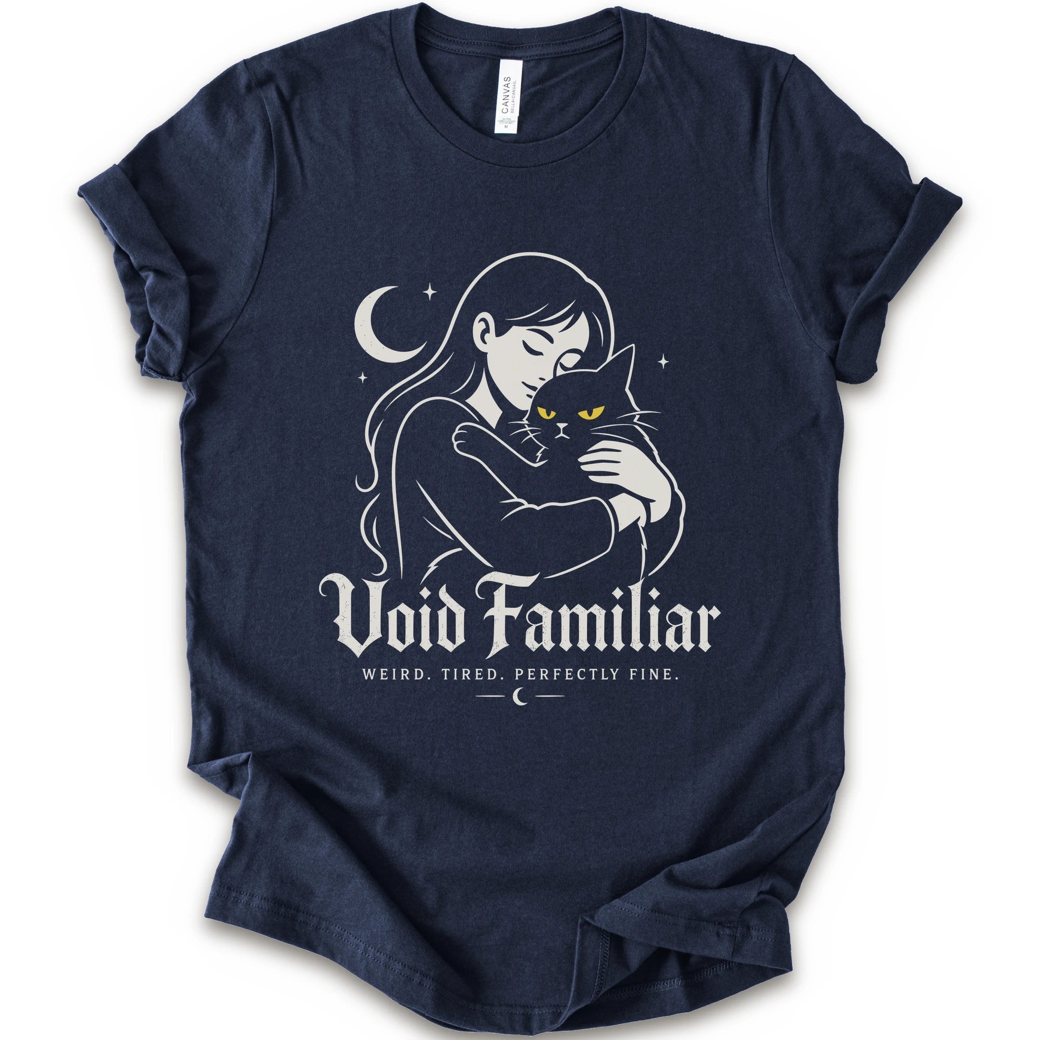 Navy graphic t-shirt with a woman hugging a black cat beneath a crescent moon with “Void Familiar” and “Weird. Tired. Perfectly Fine.” text
