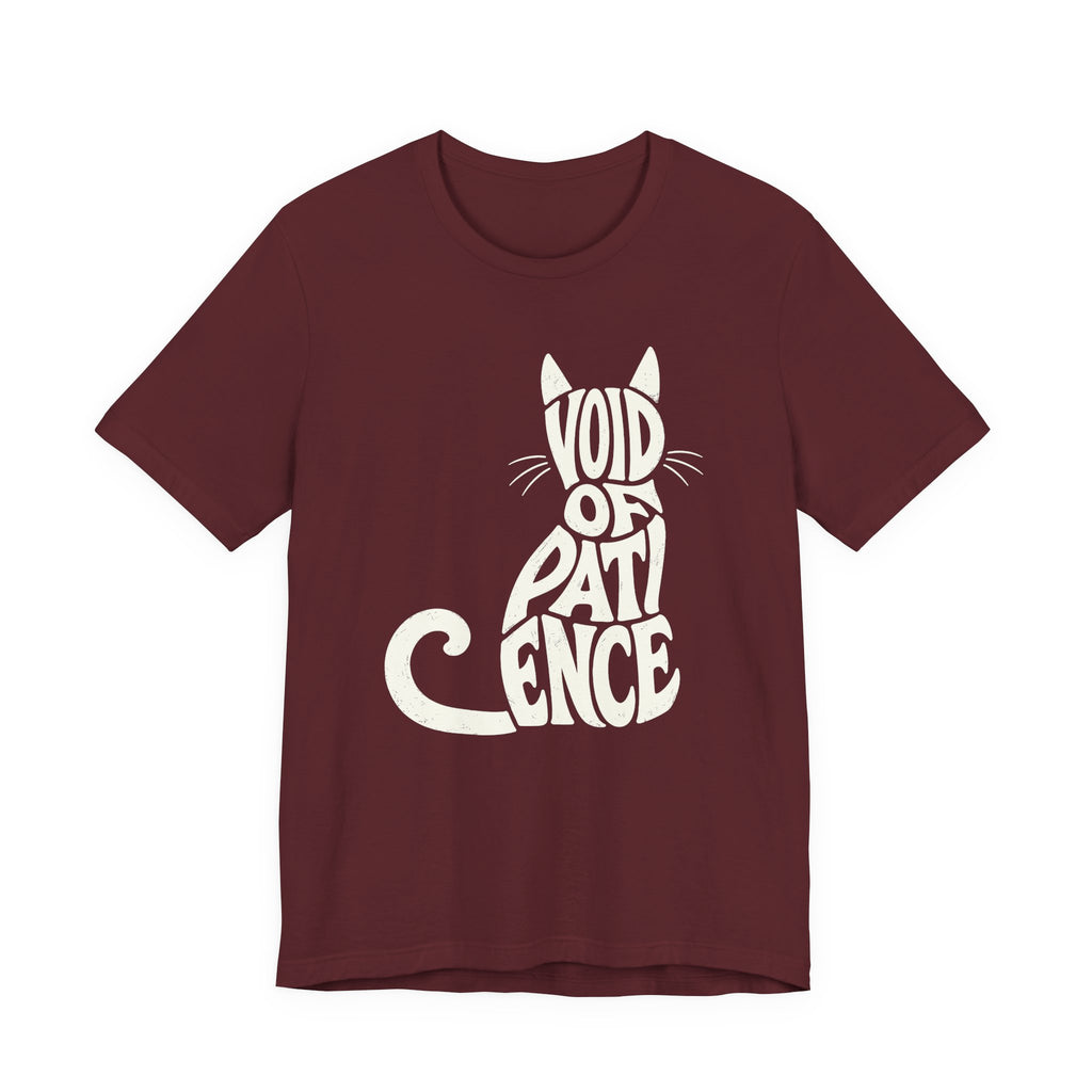 A maroon short-sleeve crewneck t-shirt featuring a graphic with “VOID OF PATIENCE” lettering arranged as a cream cat silhouette with ears, whiskers, and a curled tail
