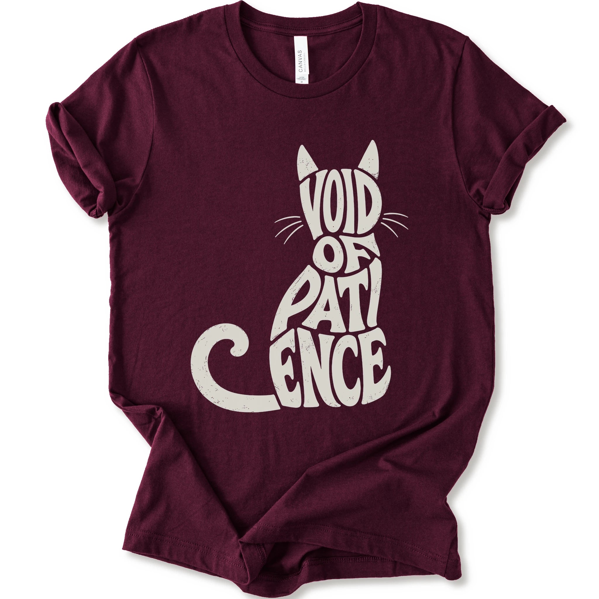 Maroon graphic t-shirt with “VOID OF PATIENCE” lettering arranged as a cat silhouette with ears, whiskers, and a curled tail