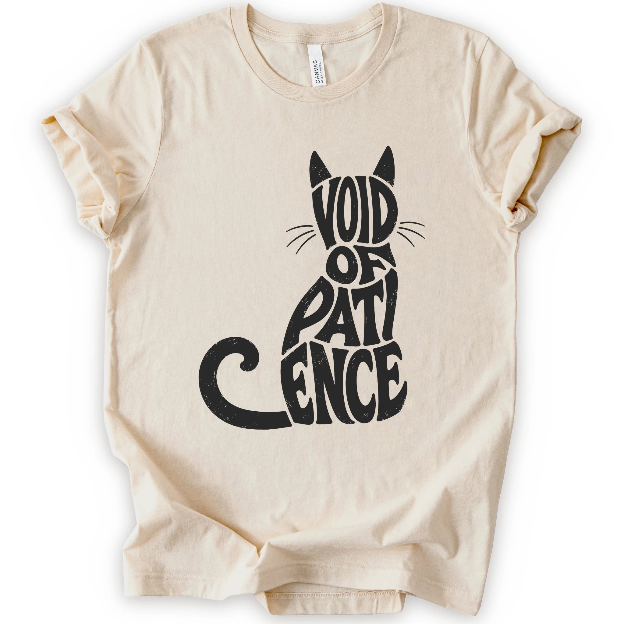 Natural graphic t-shirt with “VOID OF PATIENCE” lettering arranged as a cat silhouette with ears, whiskers, and a curled tail