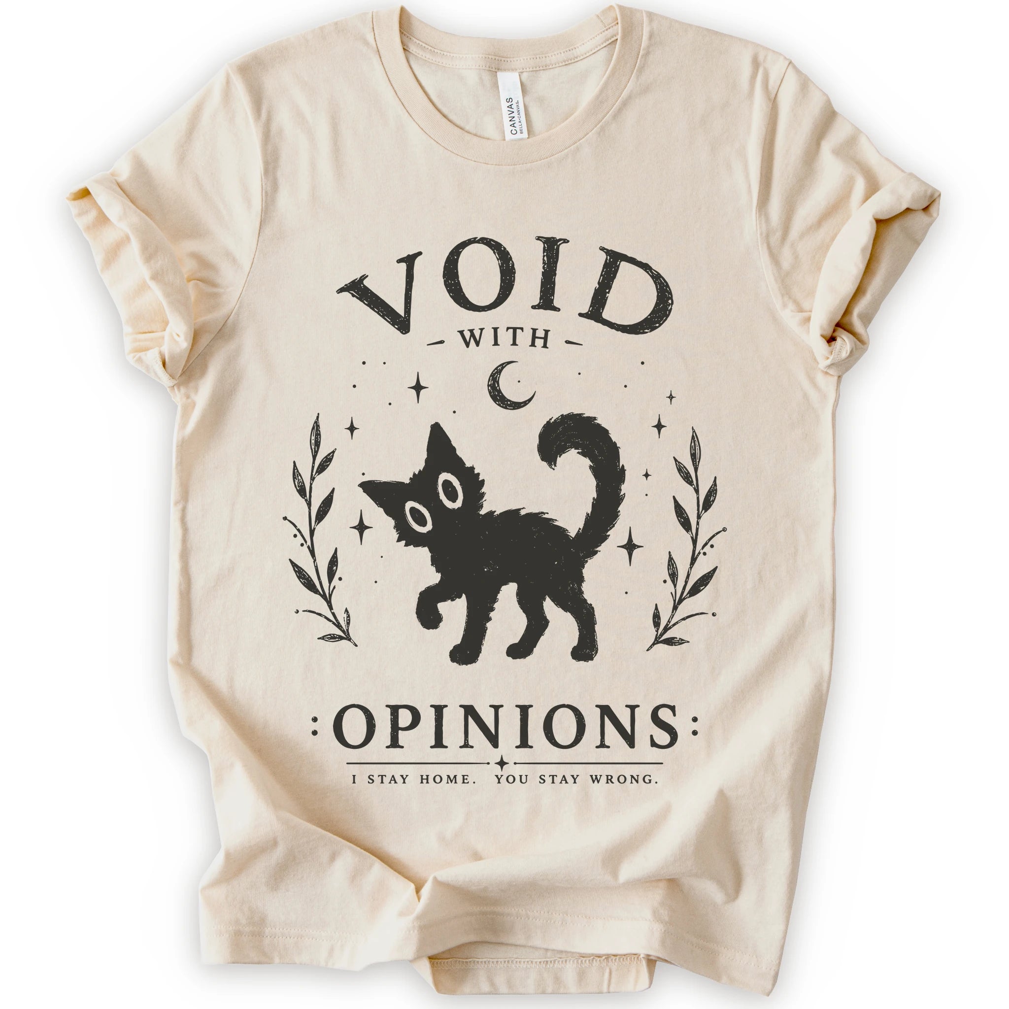 A natural short-sleeve t-shirt with a black graphic print featuring a cat, stars, and the text 'VOID WITH OPINIONS'.