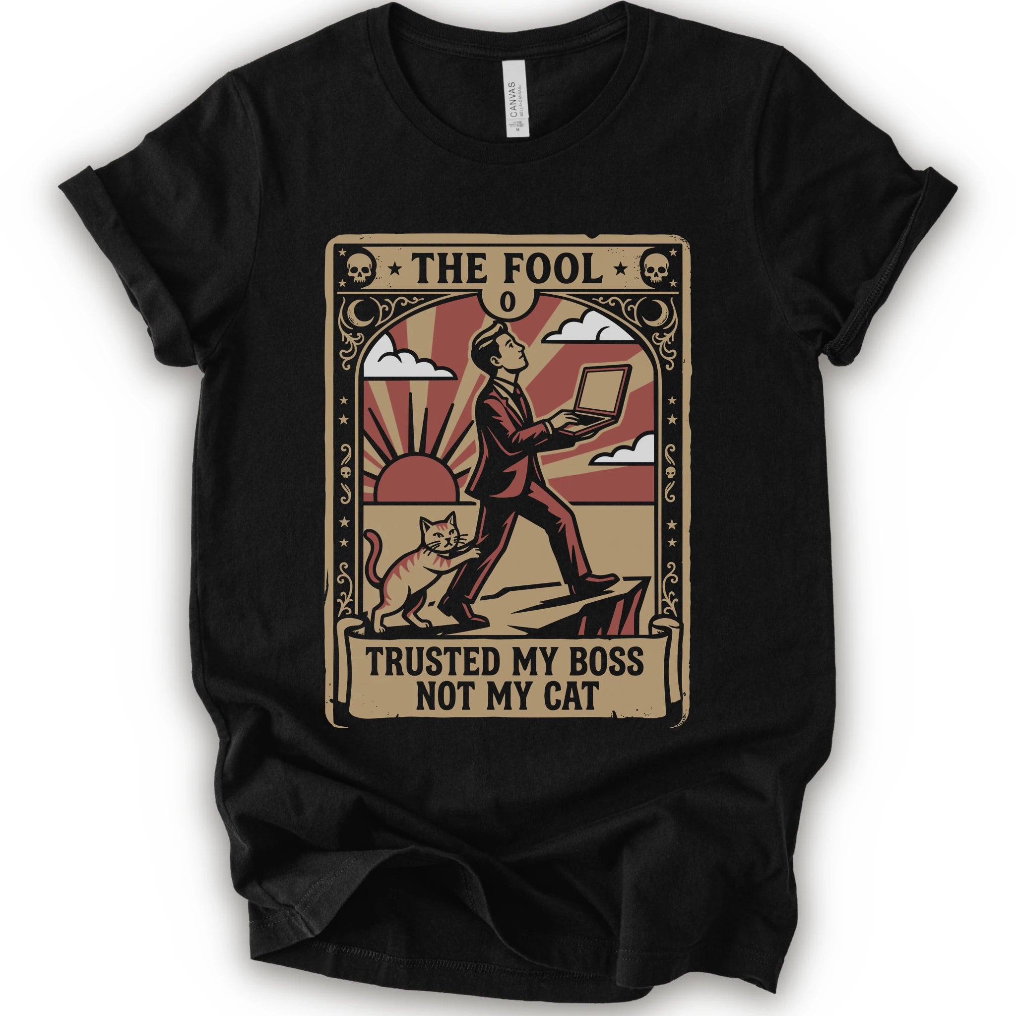 A black short-sleeve crewneck t-shirt with a vintage-style graphic print on the front. The graphic is styled like an old tarot card, featuring a man in a suit walking on a cliff while a cat watches, with the text 'THE FOOL' at the top and 'TRUSTED MY BOSS NOT MY CAT' at the bottom.