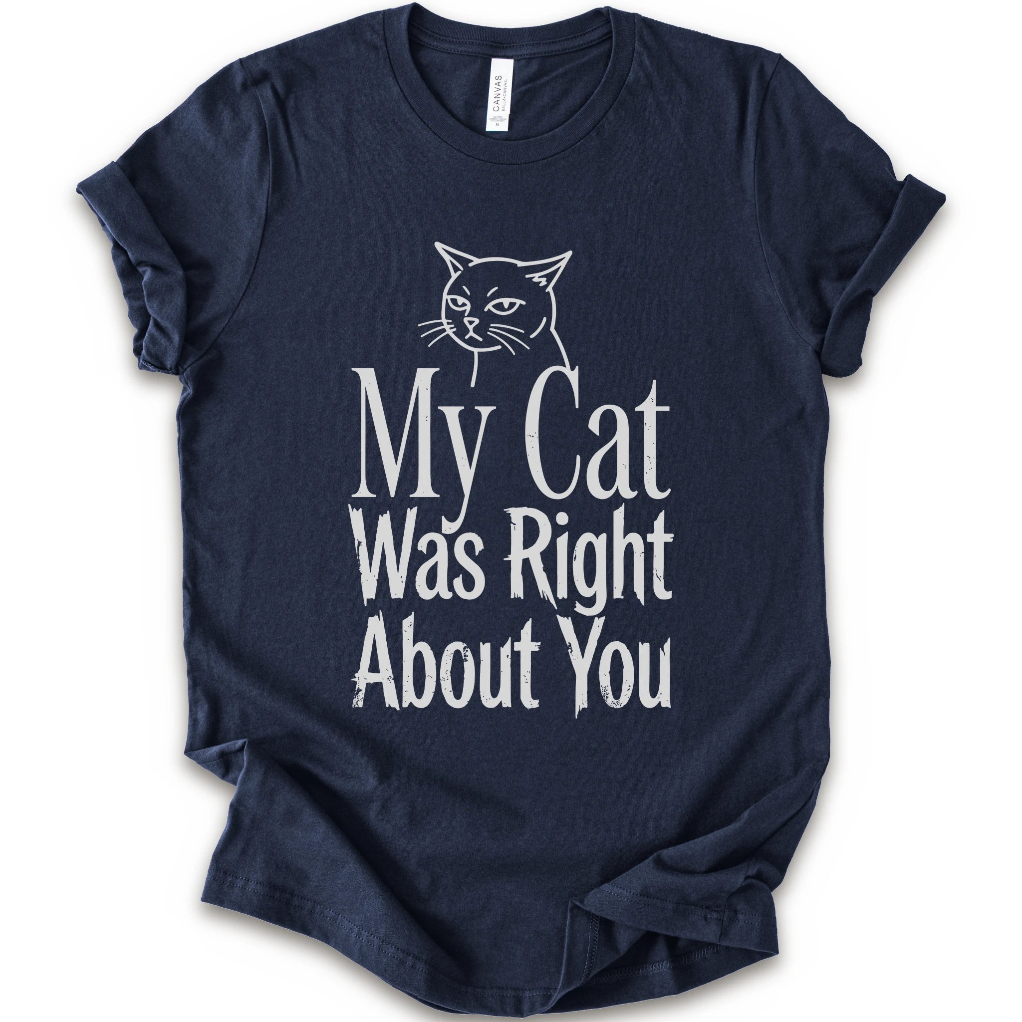 A navy short-sleeve crewneck T-shirt with a cat rendered in white outline sits above the text “My Cat Was Right About You,” arranged in oversized mixed serif and distressed lettering.