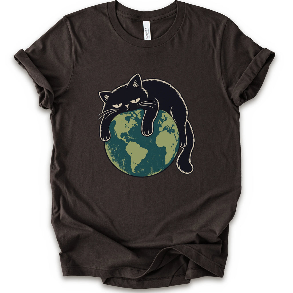 A brown short-sleeve crewneck t-shirt featuring a graphic of a grumpy black cat draped over a green and blue globe.