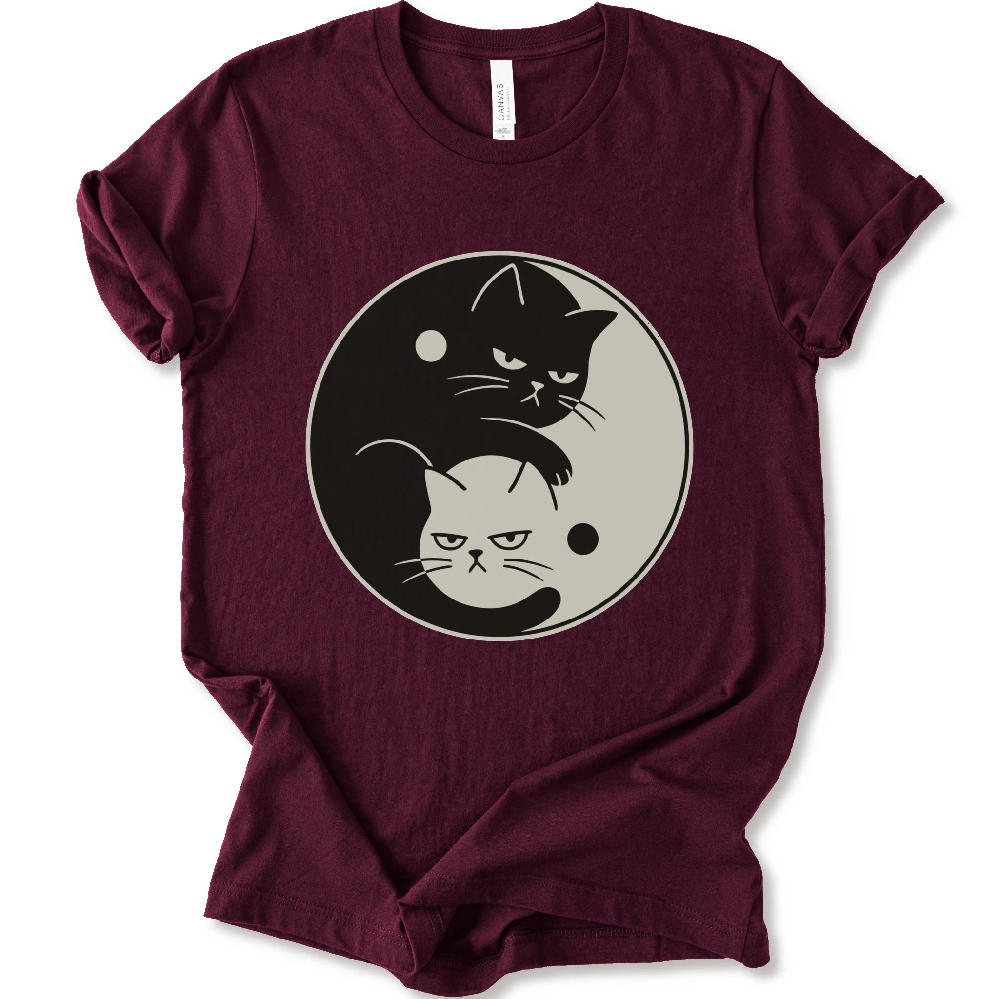 Maroon graphic t-shirt with two unimpressed cats, one black and one light, arranged in a yin-yang symbol