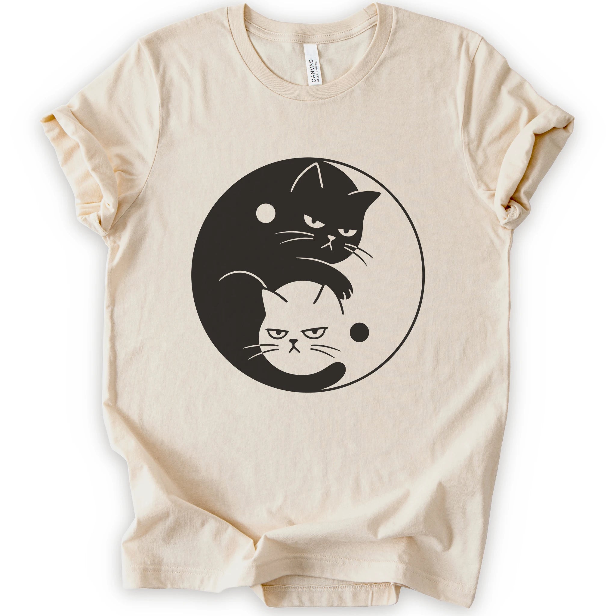 Natural graphic t-shirt with two unimpressed cats, one black and one light, arranged in a yin-yang symbol