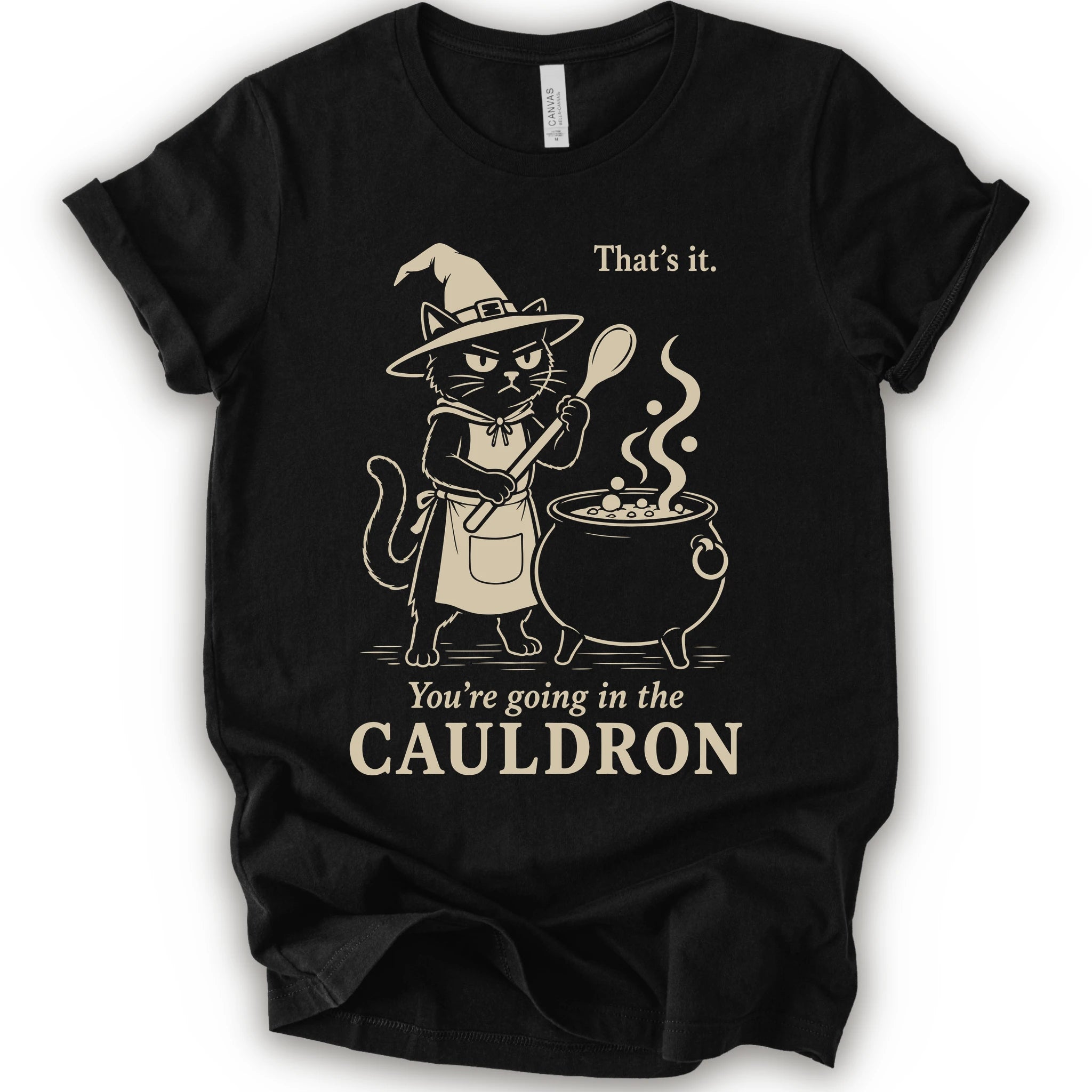 Black graphic t-shirt with cat as a witch stirring a bubbling cauldron with “That’s it, you’re going in the cauldron” text