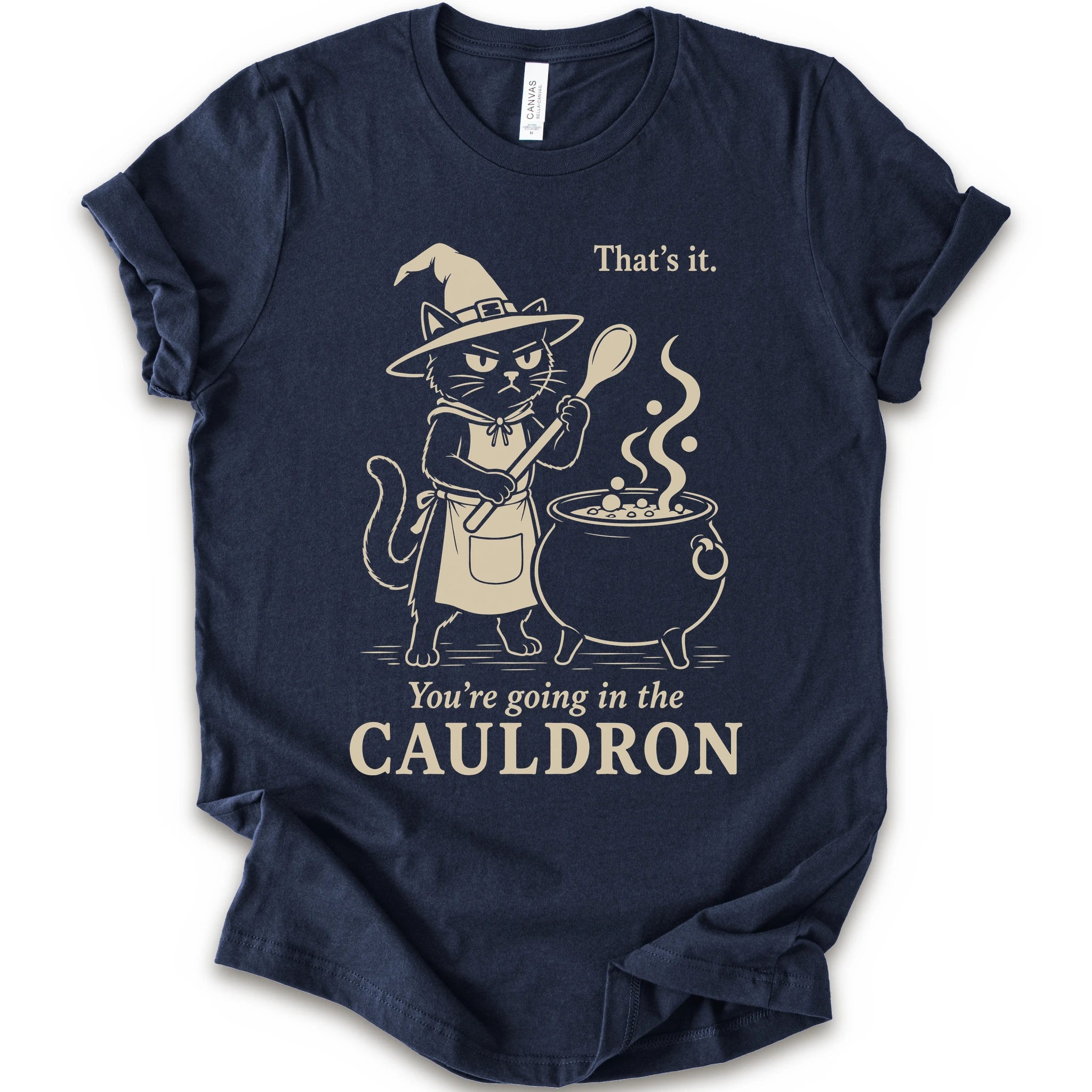 Navy graphic t-shirt with cat as a witch stirring a bubbling cauldron with “That’s it, you’re going in the cauldron” text